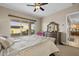 Bedroom with sliding glass doors to backyard, decorative dresser with mirror, and bright pink chair at 5258 S Verde --, Mesa, AZ 85212