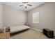 Neutral-toned bedroom featuring a futon bed, ceiling fan, and natural light from the window at 5258 S Verde --, Mesa, AZ 85212