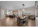 Spacious dining room featuring a large wooden table and modern lighting fixtures next to the island and kitchen at 5258 S Verde --, Mesa, AZ 85212