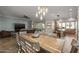 Open-concept dining room features a wooden table with seating for six and views of the living room at 5258 S Verde --, Mesa, AZ 85212