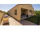 The backyard exterior showcases a covered patio area, brick pavers, and well maintained synthetic grass at 5258 S Verde --, Mesa, AZ 85212