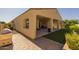 The backyard exterior showcases a covered patio area, brick pavers, and well maintained synthetic grass at 5258 S Verde --, Mesa, AZ 85212