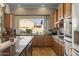 Kitchen counter with cabinets overlooking the backyard with retractable wall and stainless steel dishwasher at 5258 S Verde --, Mesa, AZ 85212
