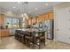 Bright kitchen boasts stainless steel appliances, a large island with seating, and pendant lighting fixtures at 5258 S Verde --, Mesa, AZ 85212