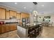 Open-concept kitchen features a large island with seating, stainless steel appliances, and granite countertops at 5258 S Verde --, Mesa, AZ 85212