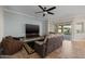 Cozy living room with a ceiling fan, large TV, and a comfortable seating arrangement at 5258 S Verde --, Mesa, AZ 85212