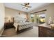 Bedroom with a large bed, sliding glass door to the backyard, ceiling fan, and a neutral color palette at 5258 S Verde --, Mesa, AZ 85212