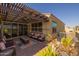 Outdoor patio featuring a covered pergola, lounge seating, and decorative desert landscaping at 5258 S Verde --, Mesa, AZ 85212