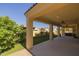 Expansive covered patio overlooks meticulously maintained synthetic grass and lush backyard landscaping at 5258 S Verde --, Mesa, AZ 85212