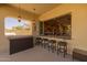 The covered patio offers a bar area, seating and an accordion window to the kitchen at 5258 S Verde --, Mesa, AZ 85212