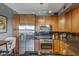 Well-equipped kitchen with stainless steel appliances, granite counters, and stylish wood cabinetry at 5303 N 7Th St # 331, Phoenix, AZ 85014
