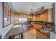 Open kitchen with stainless appliances, wood cabinets, granite countertop, and adjacent dining area at 5303 N 7Th St # 331, Phoenix, AZ 85014