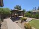 Inviting backyard featuring a built-in BBQ, lush landscaping, and a relaxing outdoor living space at 549 E Benrich Dr, Gilbert, AZ 85295