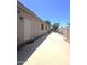 Exterior view of the side yard featuring stone, block fence, and small trees at 549 E Benrich Dr, Gilbert, AZ 85295