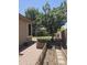 Backyard featuring garden plot, stone pavers and mature trees at 549 E Benrich Dr, Gilbert, AZ 85295