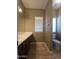 Bathroom with vanity sink, neutral-toned walls, a large mirror, and natural lighting with a toilet at 549 E Benrich Dr, Gilbert, AZ 85295