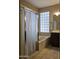 Bright bathroom with separate shower, tub, and a glass block window at 549 E Benrich Dr, Gilbert, AZ 85295