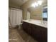 Bathroom featuring double sink vanity and shower with tiled surround at 549 E Benrich Dr, Gilbert, AZ 85295