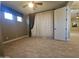 Spacious bedroom with tile flooring, neutral walls, natural light, and access to adjoining rooms through open doorways at 549 E Benrich Dr, Gilbert, AZ 85295