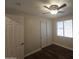 Bedroom featuring laminate floors, ceiling fan and closet doors at 549 E Benrich Dr, Gilbert, AZ 85295