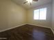 Bright bedroom featuring dark laminate flooring and a ceiling fan at 549 E Benrich Dr, Gilbert, AZ 85295
