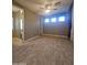 Spacious bedroom with a ceiling fan, tile flooring, ensuite bathroom, and natural light from three windows at 549 E Benrich Dr, Gilbert, AZ 85295
