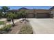 Charming home featuring a three-car garage, desert landscaping, and a welcoming entrance at 549 E Benrich Dr, Gilbert, AZ 85295