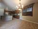 Spacious kitchen featuring granite countertops, stainless steel appliances, and stylish pendant lighting at 549 E Benrich Dr, Gilbert, AZ 85295