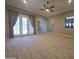 Spacious living room with tile floors, ceiling fan, and french doors to the outside at 549 E Benrich Dr, Gilbert, AZ 85295