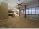 Spacious open living room with tile floors, neutral colors, and a view into the kitchen at 549 E Benrich Dr, Gilbert, AZ 85295