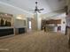 Living room with fireplace and an archway to the kitchen with stainless appliances at 549 E Benrich Dr, Gilbert, AZ 85295