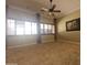 Bright living room with neutral walls, crown molding, ceiling fan, and plantation shutters at 549 E Benrich Dr, Gilbert, AZ 85295