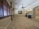 Spacious living room with fireplace, ceiling fan and beautiful travertine floors at 549 E Benrich Dr, Gilbert, AZ 85295