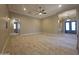 Large open-concept living room with tile floors, neutral walls, and archways to other rooms at 549 E Benrich Dr, Gilbert, AZ 85295