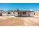 View of the back of the house and the covered patio, overlooking the backyard at 6223 W Earll Dr, Phoenix, AZ 85033