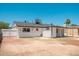 Back of the house with a spacious backyard and covered patio for outdoor living at 6223 W Earll Dr, Phoenix, AZ 85033