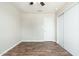 Clean bedroom with wood-look flooring, ceiling fan, and closet space at 6223 W Earll Dr, Phoenix, AZ 85033