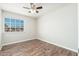 Bedroom with natural light, ceiling fan, and wood-look flooring at 6223 W Earll Dr, Phoenix, AZ 85033