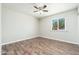 Bright bedroom featuring a window overlooking the outdoors and wood-look floors at 6223 W Earll Dr, Phoenix, AZ 85033