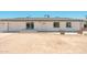 Welcoming exterior view of a single-story home featuring a freshly painted white facade and a desert landscape at 6223 W Earll Dr, Phoenix, AZ 85033