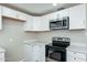 Bright kitchen featuring white cabinets, stainless steel appliances, and modern countertops at 6223 W Earll Dr, Phoenix, AZ 85033
