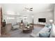 Inviting living area with an open layout to the kitchen, stylish seating, and hardwood floors at 6223 W Earll Dr, Phoenix, AZ 85033