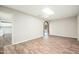 Inviting living room showcasing wood-look floors and a brick archway to another room at 6223 W Earll Dr, Phoenix, AZ 85033