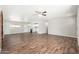 Open concept living room with a kitchen, great natural light and new vinyl flooring at 6223 W Earll Dr, Phoenix, AZ 85033