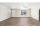 Spacious living room featuring modern wood-look flooring and a neutral color palette with lots of natural light at 6223 W Earll Dr, Phoenix, AZ 85033