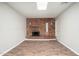 Open-concept living area featuring a classic brick fireplace and modern flooring at 6223 W Earll Dr, Phoenix, AZ 85033