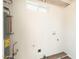 Utility room with flooring, water heater and hook-ups at 6223 W Earll Dr, Phoenix, AZ 85033