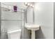 Bathroom sink with traditional fixtures, commode, and storage at 6335 W Osborn Rd, Phoenix, AZ 85033
