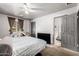 Bedroom features a window, ceiling fan, door to the bathroom, and mounted TV at 6335 W Osborn Rd, Phoenix, AZ 85033
