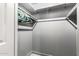 Walk-in closet with hanging clothes and gray walls at 6335 W Osborn Rd, Phoenix, AZ 85033